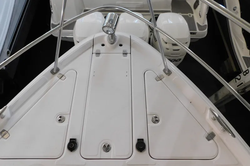 Slide: The Image of 2004 Regal Commodore 3860 boat deck with stainless steel railings and dual engines. - 104
