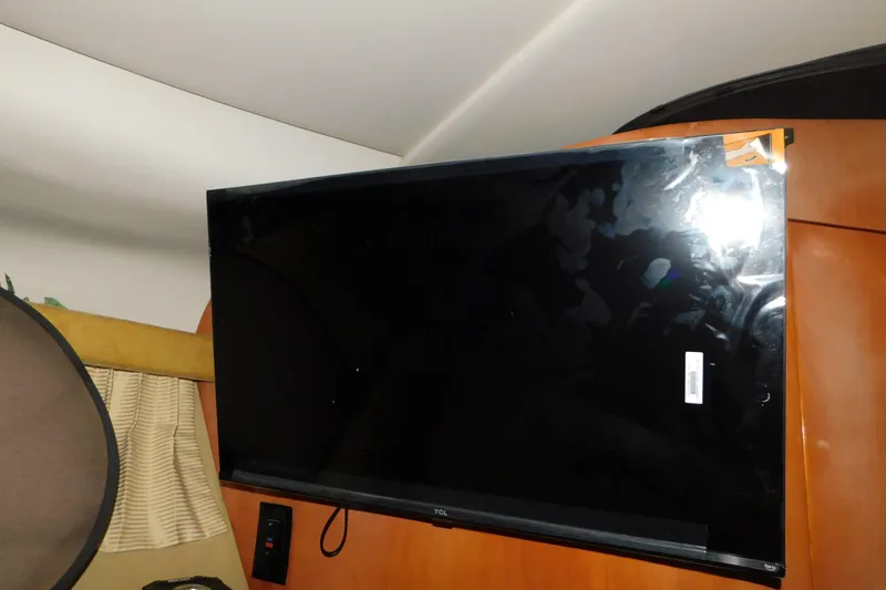 Slide: The Image of Flat-screen TV mounted inside a 2004 Regal Commodore 3860 boat cabin. - 64