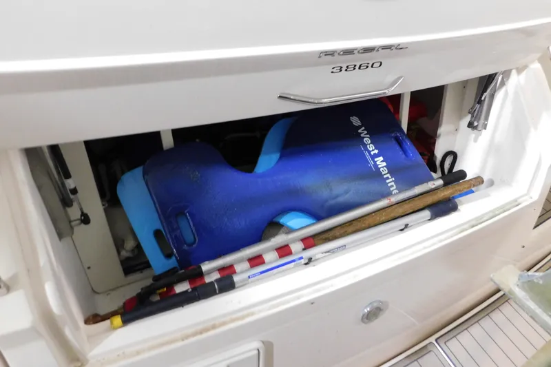 Slide: The Image of Storage compartment of a 2004 Regal Commodore 3860 boat with marine equipment. - 14