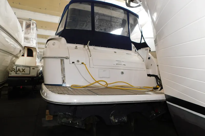 Slide: The Image of 2004 Regal Commodore 3860 yacht docked indoors with blue canopy and yellow cable. - 109