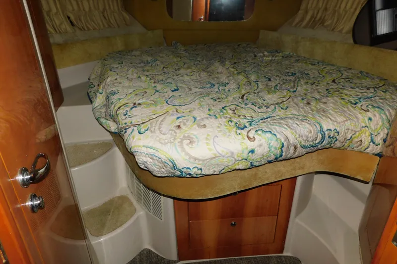 Slide: The Image of Cozy cabin interior of 2004 Regal Commodore 3860 with patterned bedding. - 60