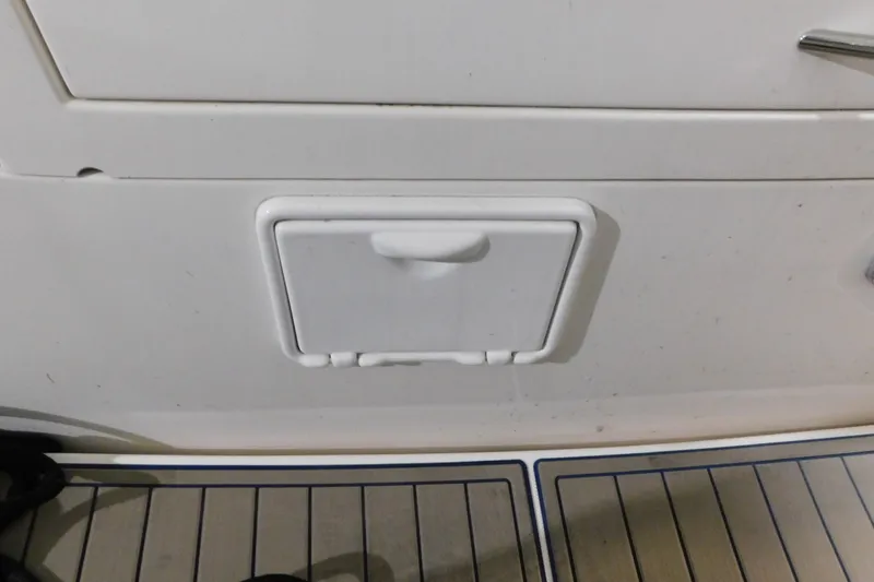 Slide: The Image of Hatch on 2004 Regal Commodore 3860 boat deck, featuring white panel and handle. - 17