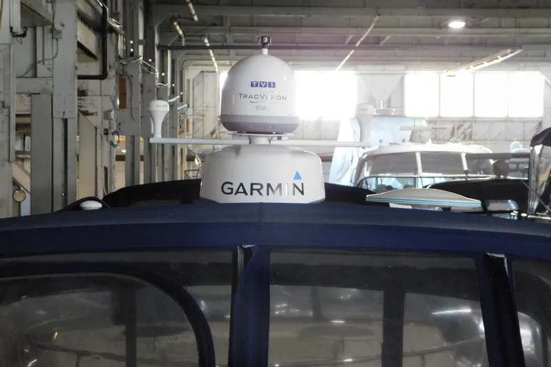 Slide: The Image of 2004 Regal Commodore 3860 with Garmin and TracVision equipment in a boat storage facility. - 103