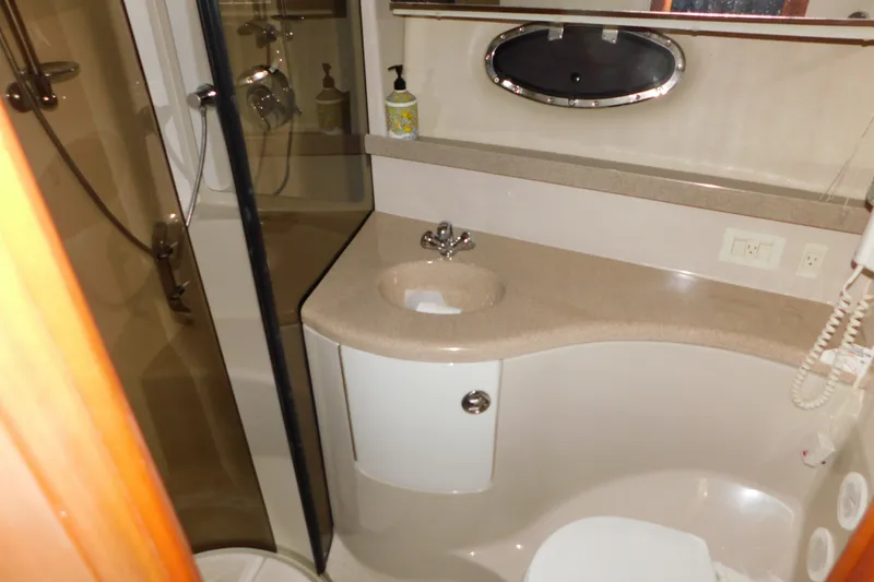 Slide: The Image of Bathroom interior of 2004 Regal Commodore 3860 yacht, featuring sink, shower, and toilet. - 68