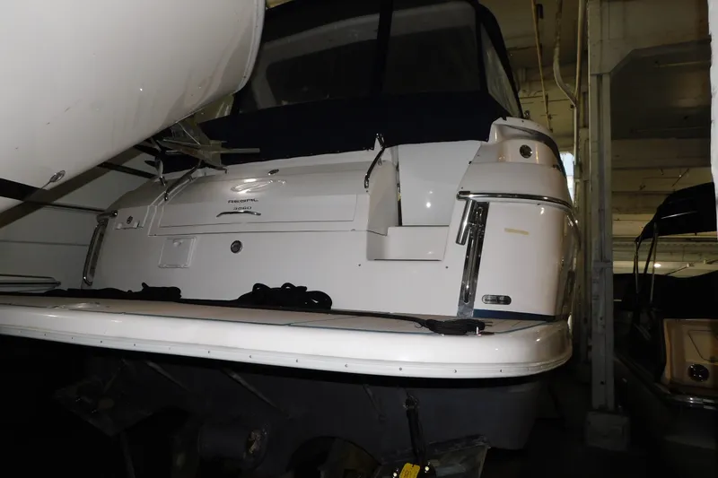 Slide: The Image of 2004 Regal Commodore 3860 yacht in storage, rear view with covered cockpit. - 1