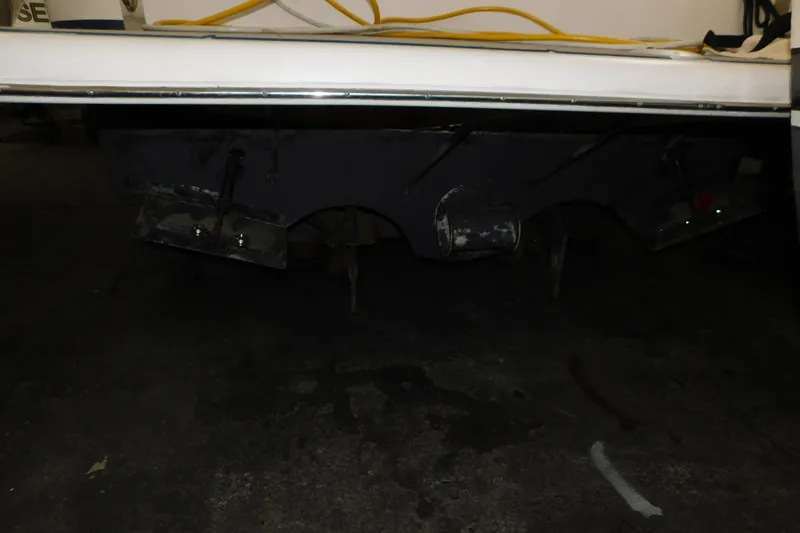 Slide: The Image of 2004 Regal Commodore 3860 boat underside with visible propellers and trim tabs. - 111