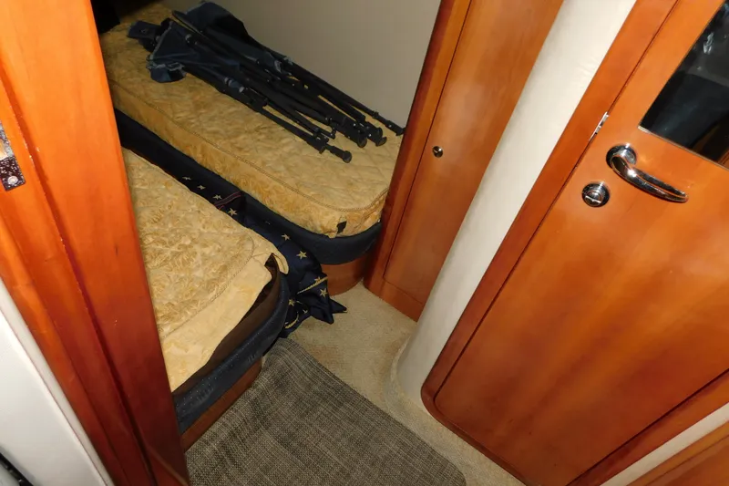 Slide: The Image of Interior cabin of 2004 Regal Commodore 3860 yacht with twin beds and wooden door. - 89
