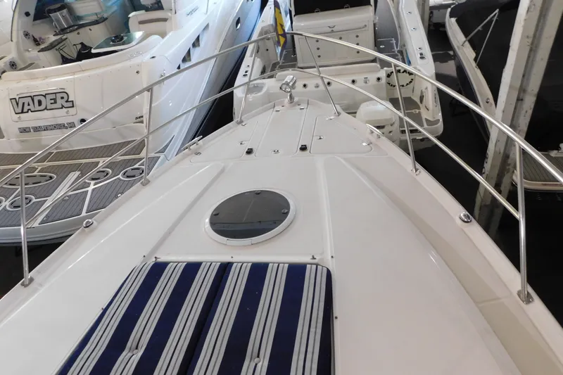 Slide: The Image of 2004 Regal Commodore 3860 yacht deck with striped seating and railing. - 99