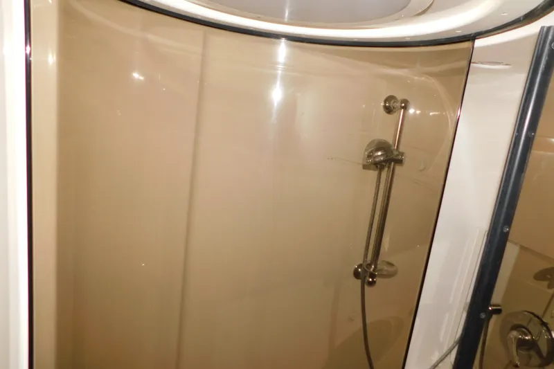 Slide: The Image of Shower area inside 2004 Regal Commodore 3860 yacht with glass door and chrome fixtures. - 71