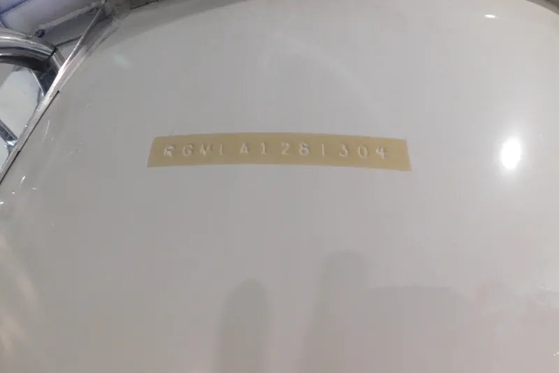 Slide: The Image of 2004 Regal Commodore 3860 hull identification number on white surface. - 113