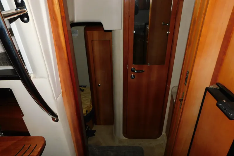Slide: The Image of Interior of 2004 Regal Commodore 3860 yacht, featuring wooden doors and compact design. - 86