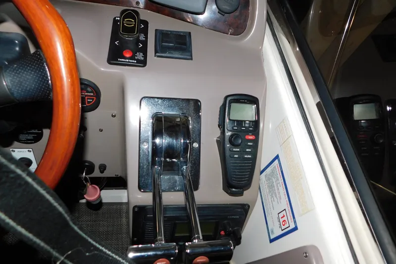 Slide: The Image of Control panel of a 2004 Regal Commodore 3860 boat with steering wheel and radio. - 43