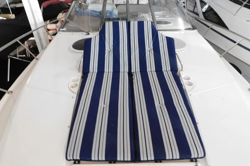 Slide: The Image of 2004 Regal Commodore 3860 boat with striped deck cushions. - 100