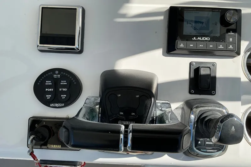 Slide: The Image of Control panel of a 2019 Sportsman Open 312 Center Console boat with Yamaha throttle. - 25