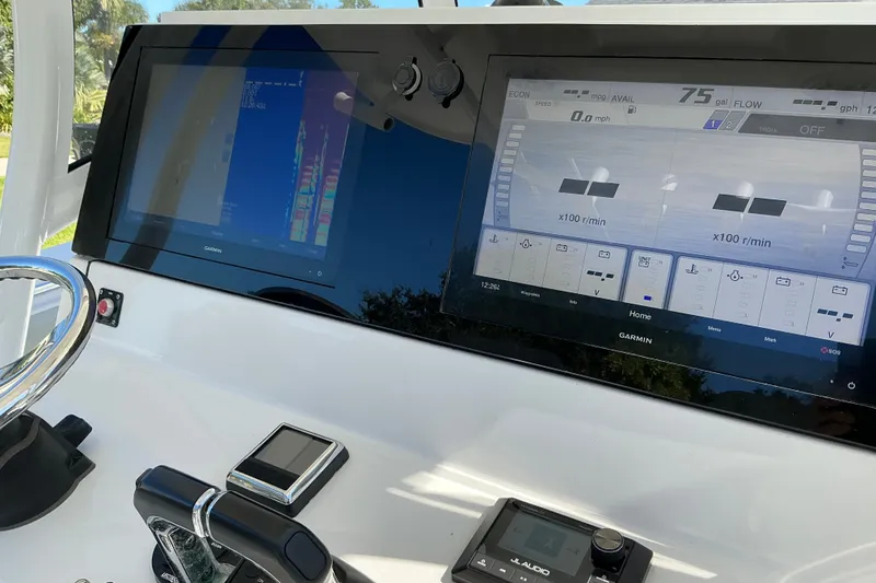 Slide: The Image of 2019 Sportsman Open 312 Center Console dashboard with Garmin displays and controls. - 24