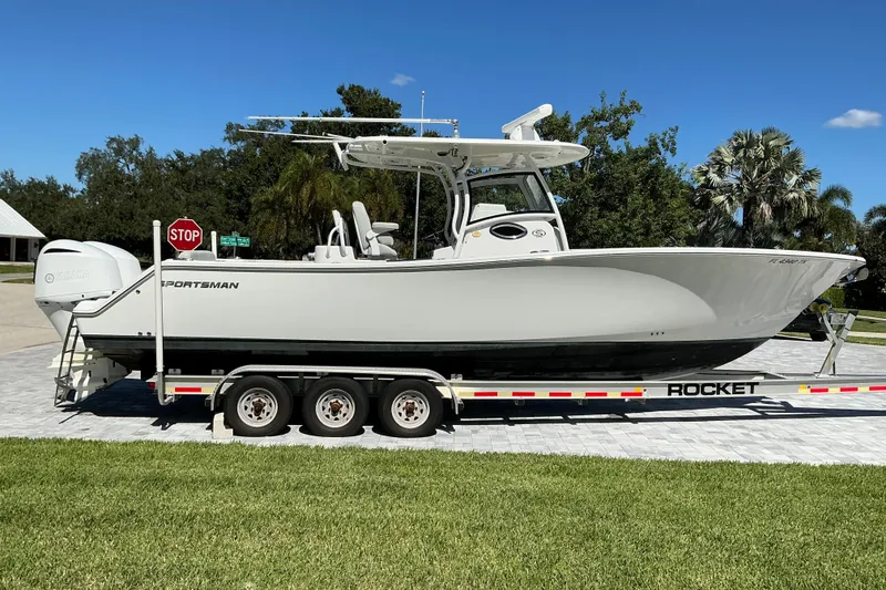 Slide: The Image of 2019 Sportsman Open 312 Center Console boat on trailer, parked outdoors. - 1