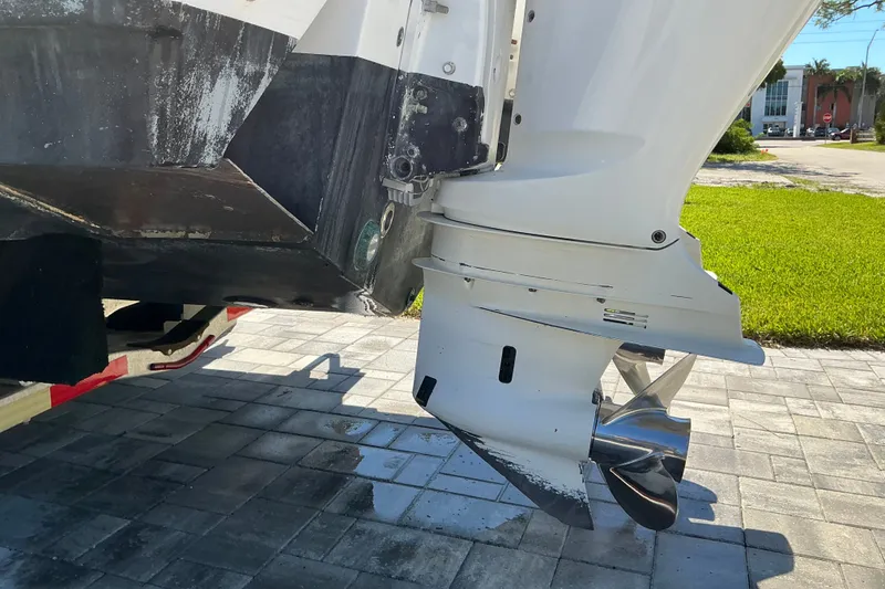 Slide: The Image of 2019 Sportsman Open 312 Center Console boat engine on a paved surface. - 20