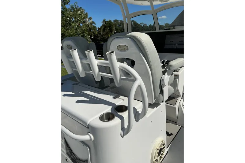 Slide: The Image of 2019 Sportsman Open 312 Center Console boat interior with rod holders and seating. - 46