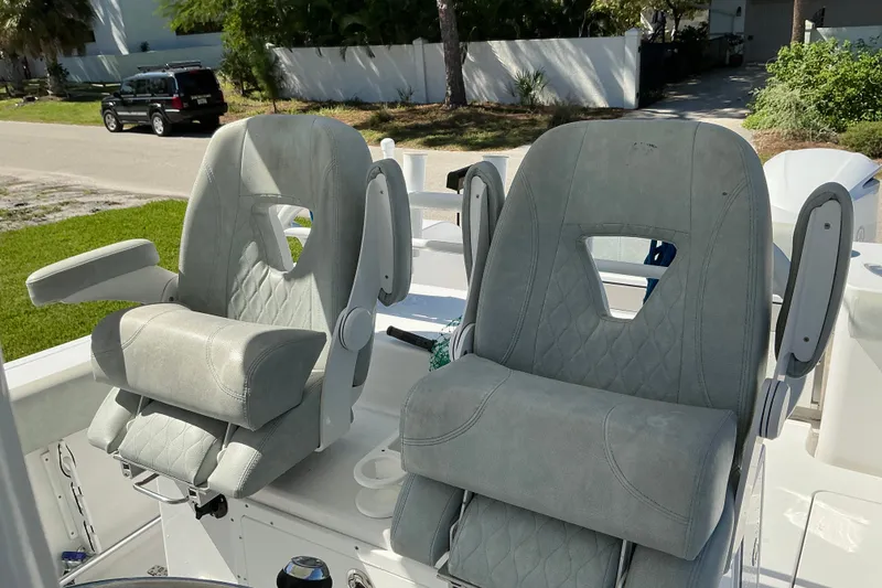 Slide: The Image of 2019 Sportsman Open 312 Center Console boat seats, featuring plush gray upholstery and armrests. - 26
