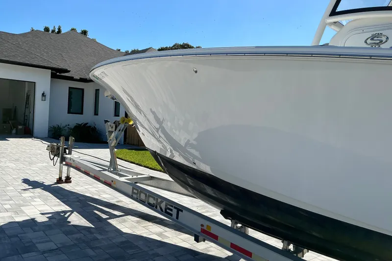 Slide: The Image of 2019 Sportsman Open 312 Center Console boat on trailer in driveway. - 7