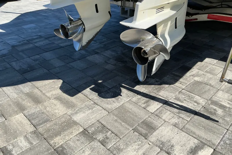 Slide: The Image of Twin propellers of a 2019 Sportsman Open 312 Center Console on a paved surface. - 11