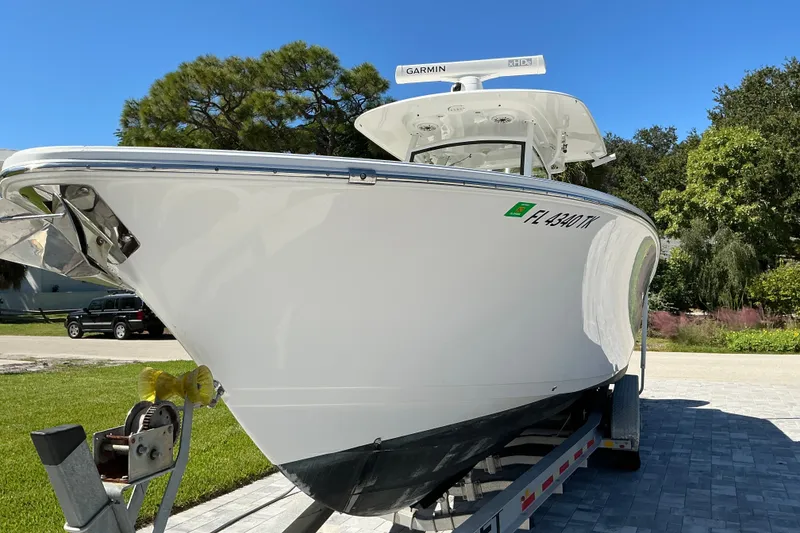 Slide: The Image of 2019 Sportsman Open 312 Center Console boat on trailer, parked outdoors. - 4