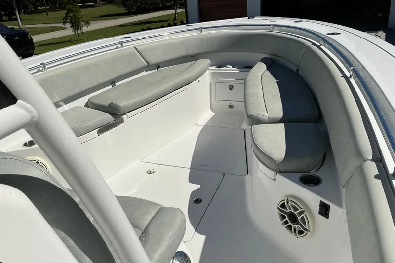 Slide: The Image of 2019 Sportsman Open 312 Center Console boat interior with cushioned seating and speaker. - 35