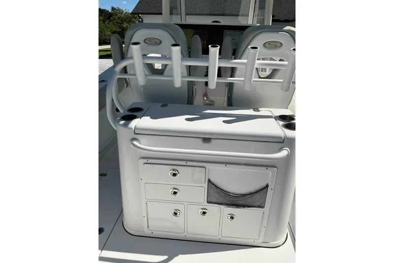 Slide: The Image of 2019 Sportsman Open 312 Center Console boat interior with storage compartments and rod holders. - 44