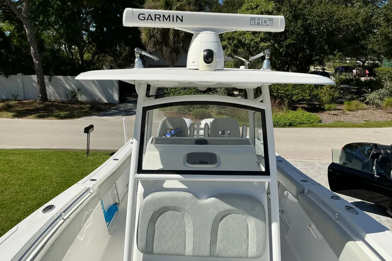 Slide: The Image of 2019 Sportsman Open 312 Center Console boat with Garmin xHD2 radar, parked outdoors. - 28