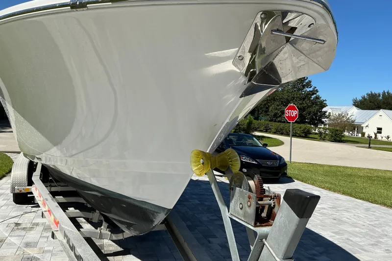 Slide: The Image of 2019 Sportsman Open 312 Center Console boat on trailer, residential street background. - 9