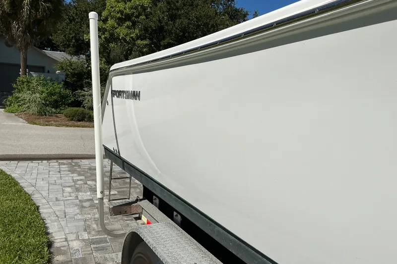 Slide: The Image of 2019 Sportsman Open 312 Center Console boat on a trailer, parked outdoors. - 12