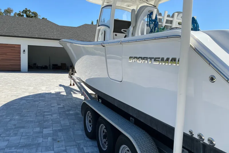 Slide: The Image of 2019 Sportsman Open 312 Center Console boat on trailer in driveway. - 5