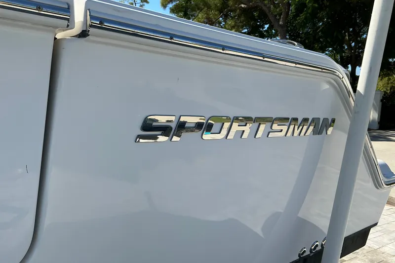 Slide: The Image of 2019 Sportsman Open 312 Center Console boat with chrome logo detail. - 49