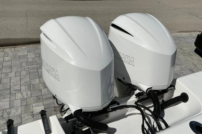 Slide: The Image of Twin Yamaha outboard engines on a 2019 Sportsman Open 312 Center Console boat. - 56