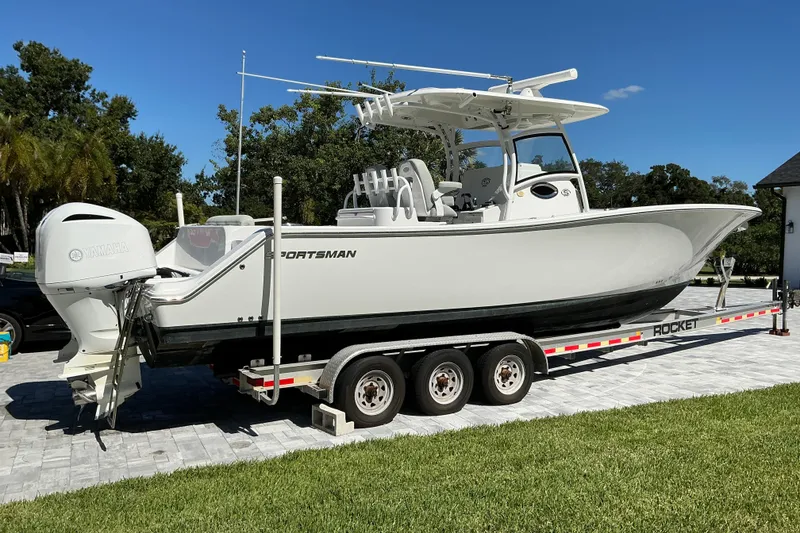 Slide: The Image of 2019 Sportsman Open 312 Center Console boat on trailer, parked outdoors. - 3