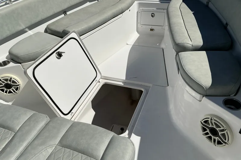 Slide: The Image of 2019 Sportsman Open 312 Center Console interior with open storage compartment and cushioned seating. - 30