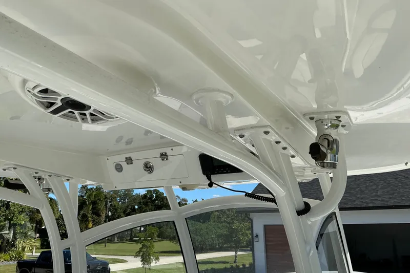 Slide: The Image of 2019 Sportsman Open 312 Center Console boat interior with speaker and rod holder. - 47
