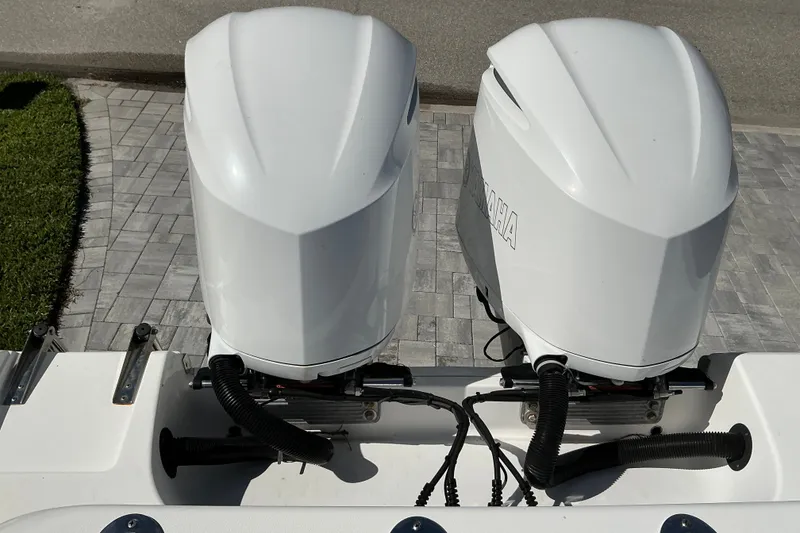 Slide: The Image of Twin Yamaha outboard engines on a 2019 Sportsman Open 312 Center Console boat. - 55