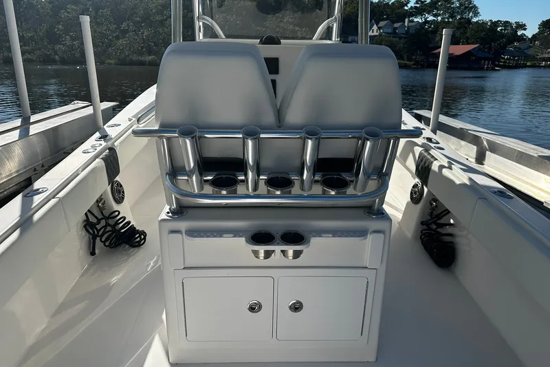 Slide: The Image of 2016 Regulator 28 Forward Seating boat interior with rod holders and storage compartments. - 25