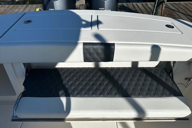 Slide: The Image of 2016 Regulator 28 Forward Seating boat with cushioned bench and storage compartment. - 13