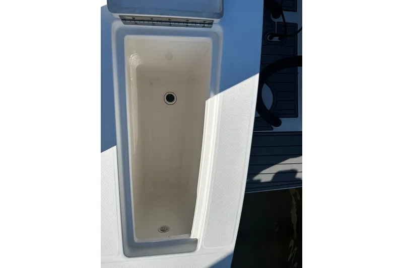Slide: The Image of Open storage compartment on 2016 Regulator 28 Forward Seating boat. - 12
