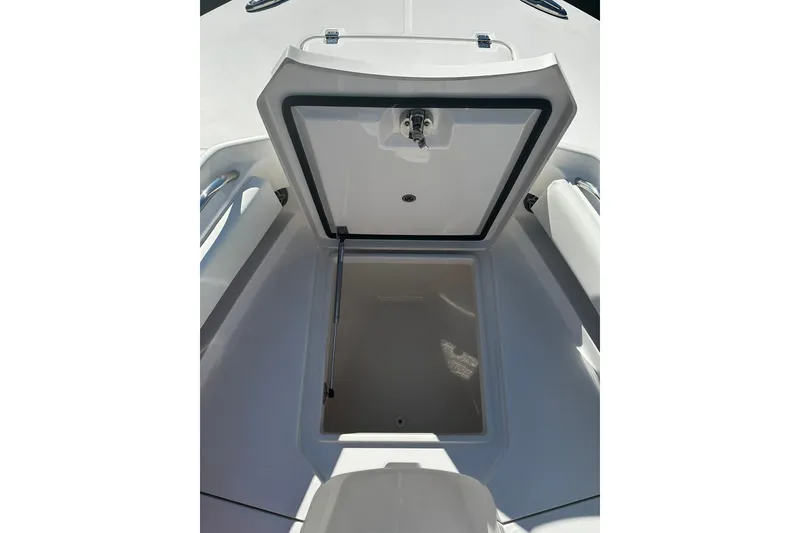 Slide: The Image of 2016 Regulator 28 Forward Seating boat with open storage compartment. - 17
