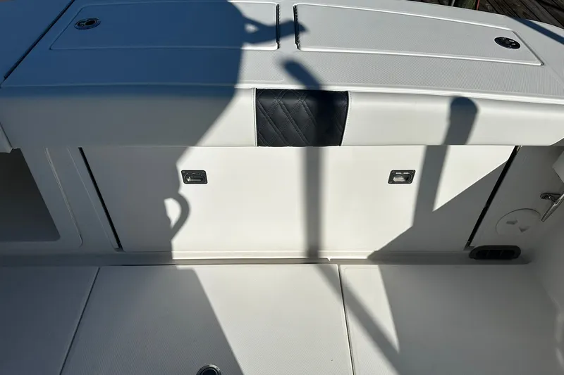 Slide: The Image of 2016 Regulator 28 Forward Seating boat interior with storage compartments. - 22
