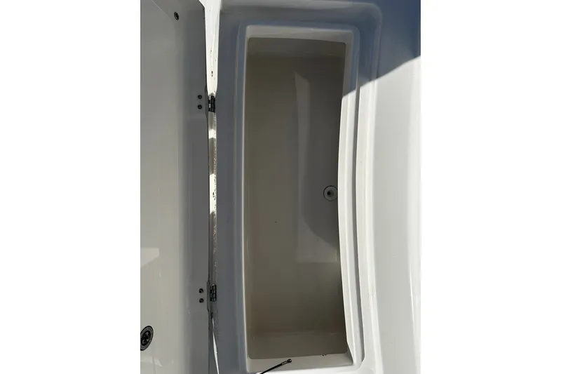 Slide: The Image of Open storage compartment on a 2016 Regulator 28 Forward Seating boat. - 10