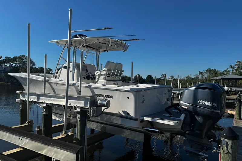 Slide: The Image of 2016 Regulator 28 Forward Seating boat with Yamaha engine on lift at marina. - 4