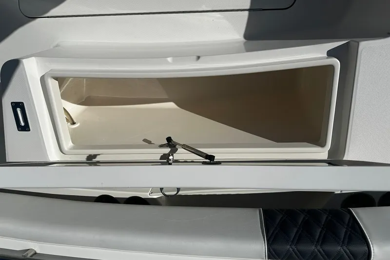 Slide: The Image of Open storage compartment on a 2016 Regulator 28 Forward Seating boat. - 9