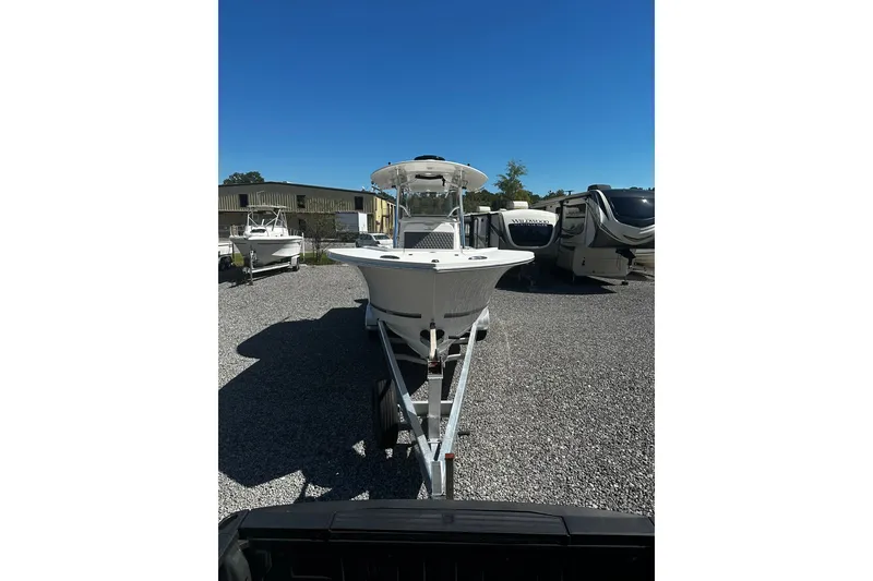 Slide: The Image of 2016 Regulator 28 Forward Seating boat on trailer in outdoor lot. - 1