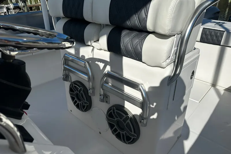 Slide: The Image of 2016 Regulator 28 Forward Seating boat interior with cushioned seats and stainless steel details. - 28