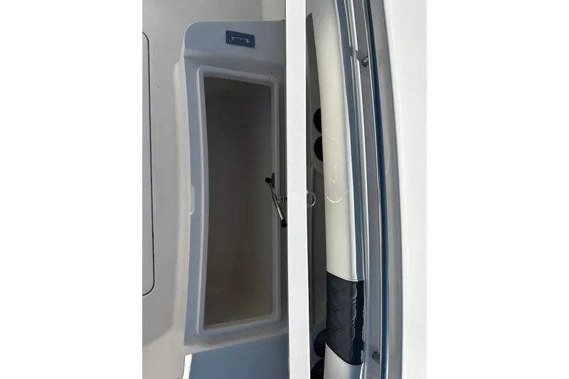 Slide: The Image of Open storage compartment on a 2016 Regulator 28 Forward Seating boat. - 8
