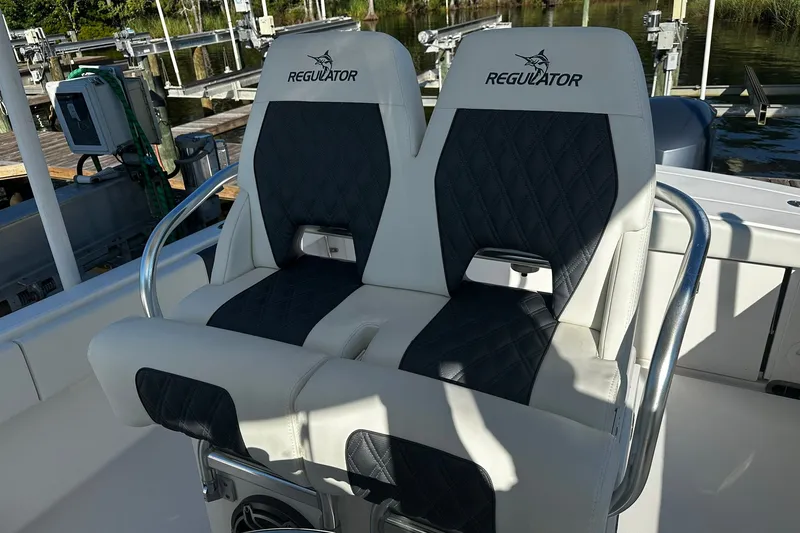 Slide: The Image of 2016 Regulator 28 Forward Seating boat with dual cushioned seats and stainless steel armrests. - 27